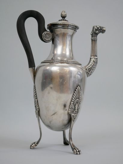 null A silver coffee pot with a tripod base chased with palmettes and horses' heads...