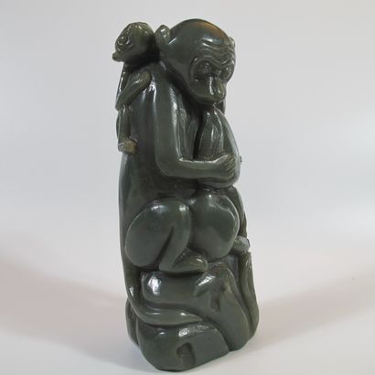 null Jade statuette with a monkey carrying a child and protecting the peaches of...