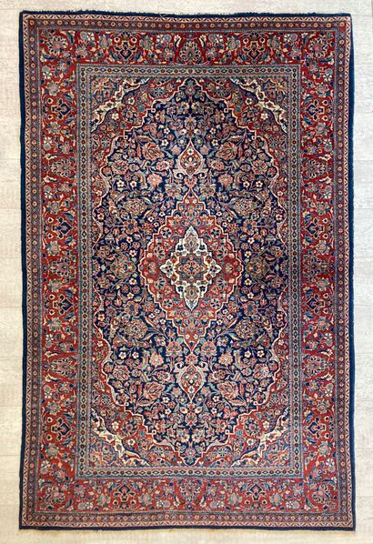null Persian wool carpet with a navy background decorated with a medallion and four...