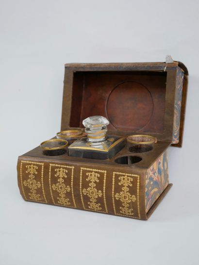 null lot: trompe l'oeil book concealing a liqueur cellar, gilded metal and horn caviar...