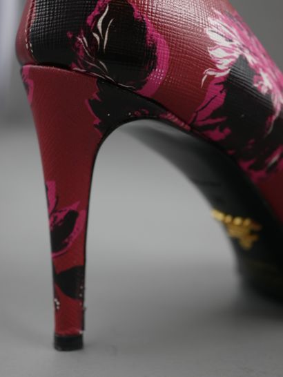 null 
PRADA. Pair of red leather pumps with black and pink flowers. Size 39. Heel...