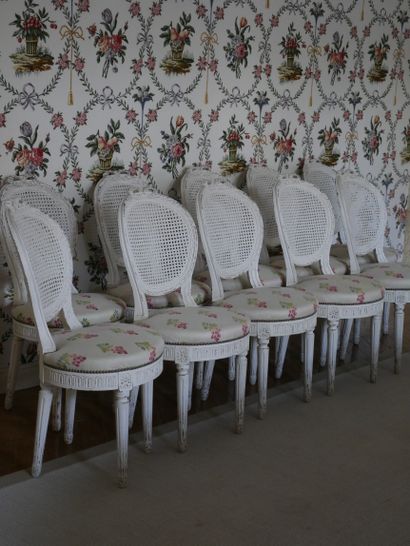 null Suite of ten moulded, carved and cream lacquered chairs, with cabriolet and...