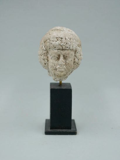 null Head of a dignitary with characteristic headdress. Limestone formerly polychrome....
