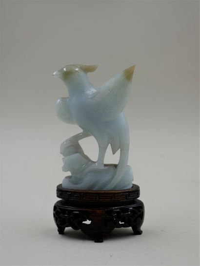 null Jadeite phoenix on a carved wooden base. Height 8cm.