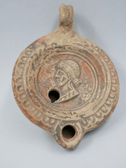 null Oil lamp. Terracotta. Female profile. Roman period. First centuries AD. L :...