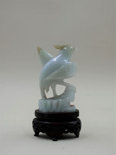 null Jadeite phoenix on a carved wooden base. Height 8cm.