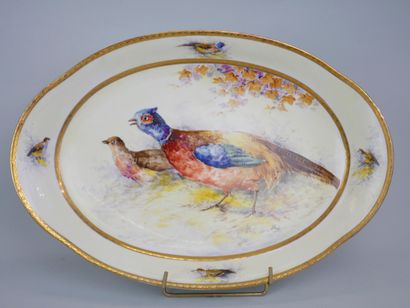 null Two oval dishes, one in Limoges porcelain decorated with a couple of pheasants...