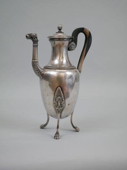 null A silver coffee pot with a tripod base chased with palmettes and horses' heads...