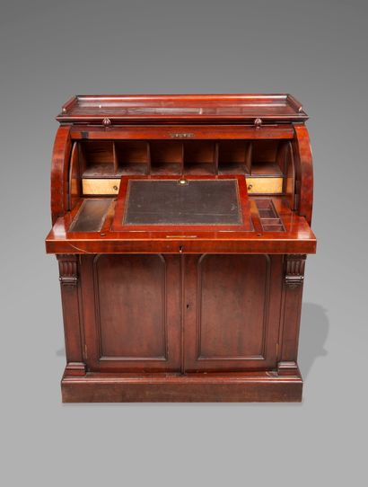 null 
A mahogany and mahogany veneer cylinder desk opening to two valances, the top...