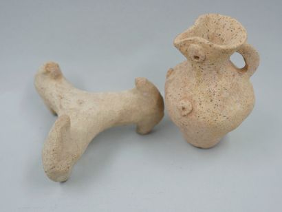 null Two terracottas. First millennium BC. Miniature oenochoe and vase support.