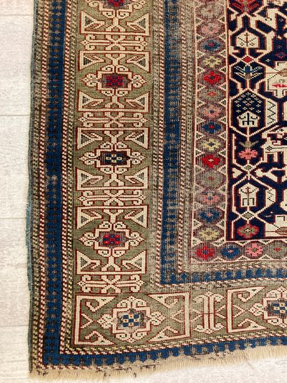 null Kazak wool carpet with stylized floral decoration on a beige background, wide...