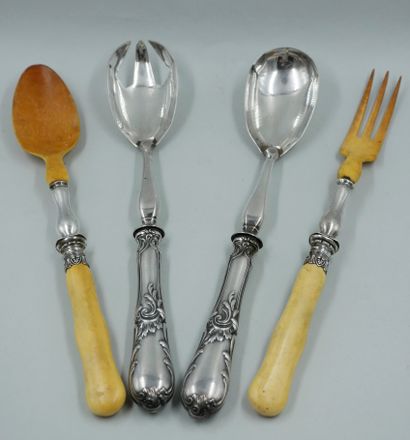 null Two pairs of metal salad servers, one in silver and ivory. (Worn). Two metal...