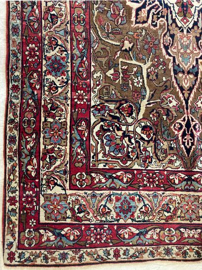 null Persian wool carpet decorated with a central medallion with flowers and four...