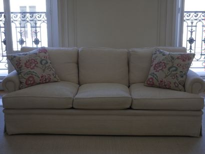 null Pair of three-seater sofas in ivory fabric, scrolled armrests. (Condition of...