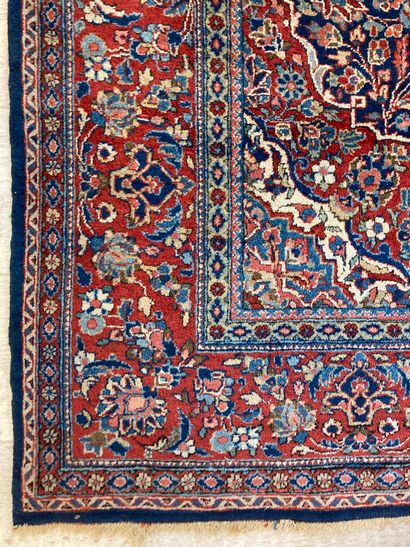 null Persian wool carpet with a navy background decorated with a medallion and four...