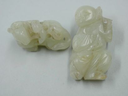 null Two carved jade netsuke representing a reclining horse and a laughing character....