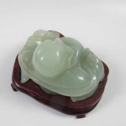 null Celadon putai on a wooden base. Nephrite jade or related. L 10 cm. H 8cm. China....