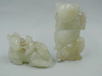 null Two carved jade netsuke representing a reclining horse and a laughing character....