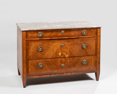 null A marquetry chest of drawers decorated with music tropes in a medallion and...