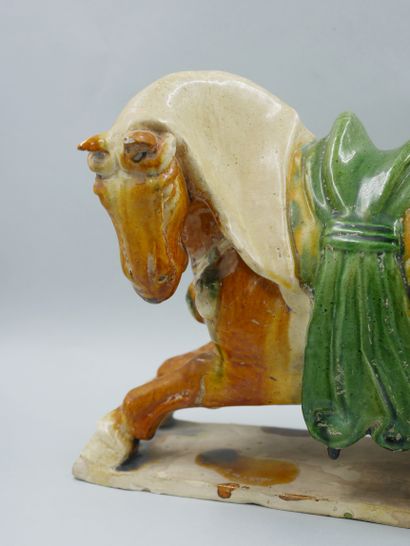 null CHINA, in the Tang style. Semi-sitting horse on a terrace. Terracotta with sancai...