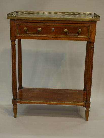 null Mahogany console table opening to a drawer in the belt. The fluted legs are...