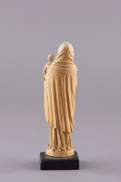 null Ivory sculpture representing the Virgin and Child. The Virgin with wavy hair...