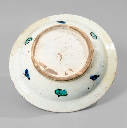 null IZNIK. Circular siliceous ceramic dish decorated in polychrome with a frieze...