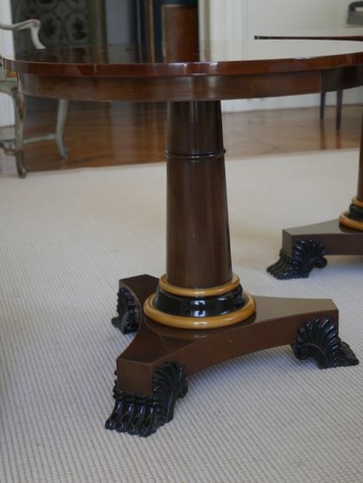 null A pair of veneered pedestal tables, the central shaft trimmed with a light wood...