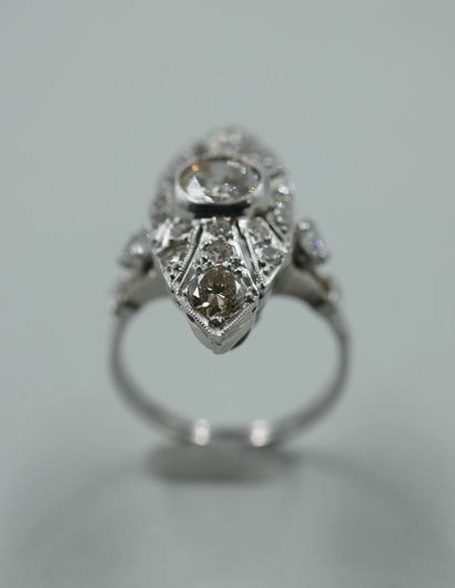 null An 18k white gold openwork marquise ring, set with a central diamond weighing...