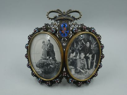 null 
RUSSIA ? Silver and gilt metal openwork photo frame presenting two glass medallions...