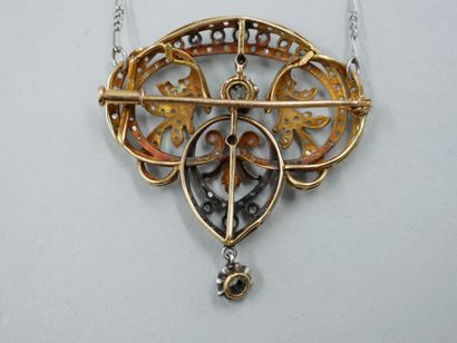 null An 18k gold and silver pendant/brooch with an openwork scroll pattern paved...