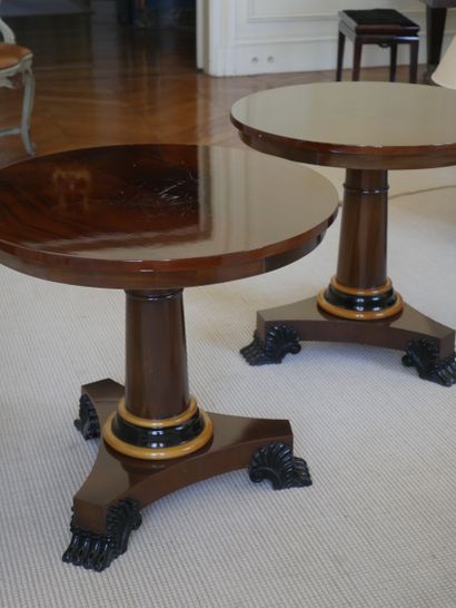 null A pair of veneered pedestal tables, the central shaft trimmed with a light wood...