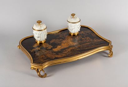 null A desk writing desk, the top in black and gold lacquer decorated with a landscape...