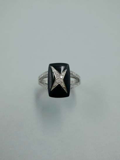 null MAUBOUSSIN. 18K white gold ring set with a cabochon of onyx centered with a...