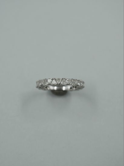 null American half wedding ring in 18k white gold set with trillion cut diamonds...