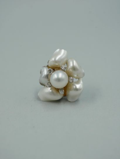 null Pair of 14k white gold flower ear clips, the heart set with a cultured pearl...