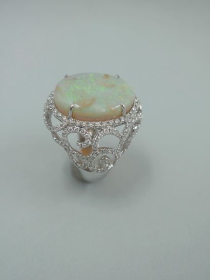 null 18k white gold ring set with a 10ct opal in an openwork design with arabesques...