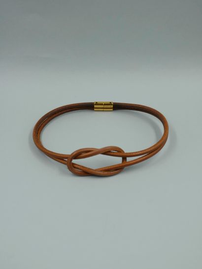 null HERMES Paris. Two-row choker necklace in natural leather forming a knot. Signed...