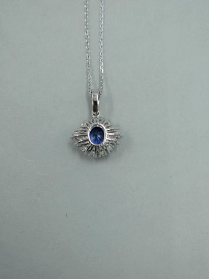 null Pendant in 18K white gold set with an oval sapphire of 0.75 ct in a setting...
