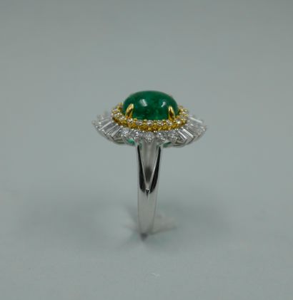 null 18k white and yellow gold skirt ring set with a cabochon emerald weighing approximately...