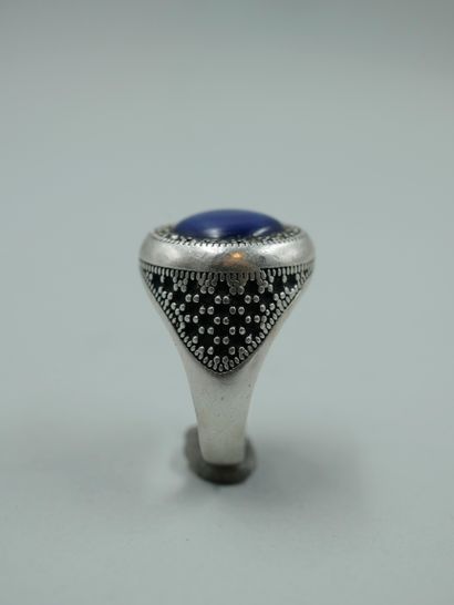 null Large silver signet ring set with a cabochon of star sapphire. (Chips). TDD...