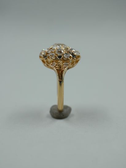 null 18k yellow gold flower ring paved with old cut cushion diamonds, the center...