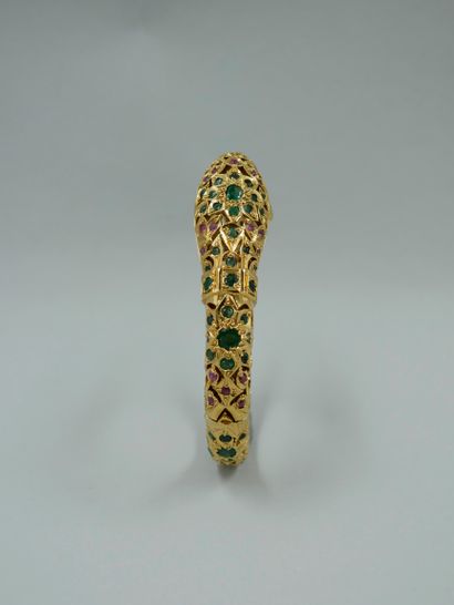 null Gold-plated openwork metal bracelet featuring a snake, set with emeralds and...