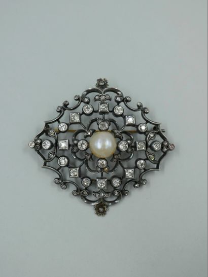 null 
14k white gold and silver brooch with openwork design, the center set with...