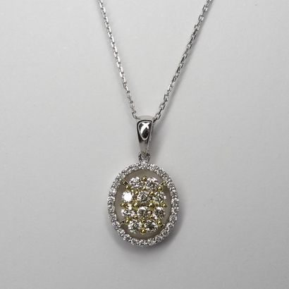null Oval openwork pendant in two 18K golds set in its center with 10 brilliant-cut...