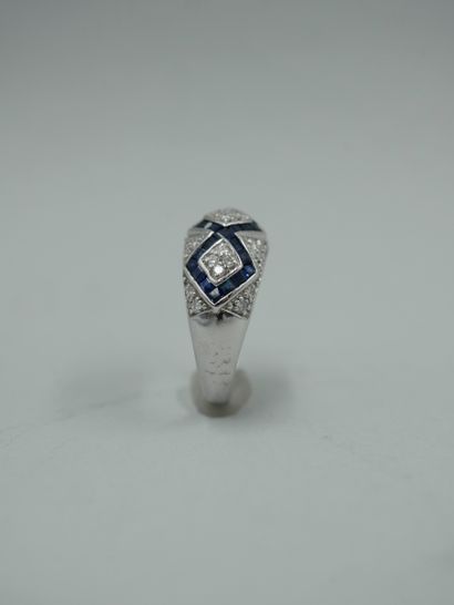 null 18K white gold ring with diamond motifs set with calibrated sapphires on a diamond...