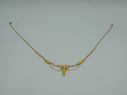 null 18k yellow gold drapery necklace with a floral and foliage design, the central...