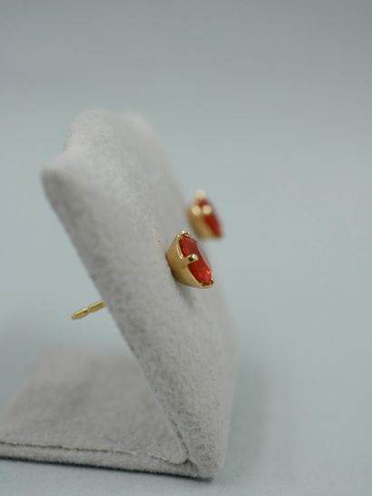 null Pair of 18K yellow gold earrings set with a round faceted fire opal. Belgian...