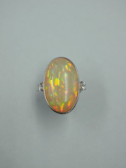 null Important 18K white gold ring set with an opal weighing about 30cts, with two...