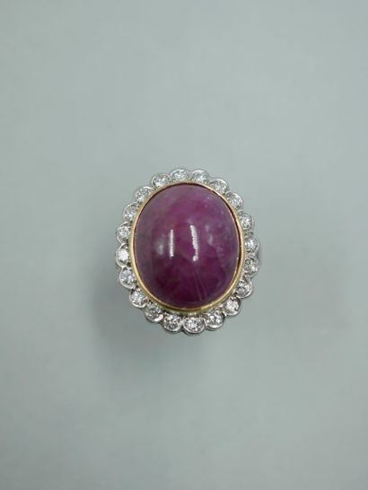 null An 18K gold ring set with a 12ct ruby root cabochon in a brilliant-cut diamond...